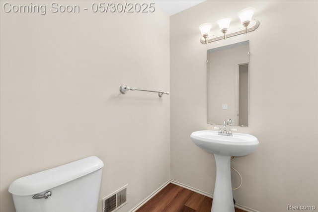 6680 Central City Pkwy, Westland, MI 48185 - half bath featuring toilet, wood finished floors, a sink, and baseboards