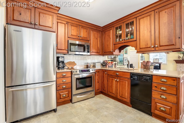 22540 Devonshire St, Woodhaven, MI 48183 - kitchen featuring stainless steel appliances and brown cabinetry