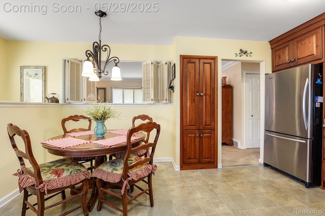 22540 Devonshire St, Woodhaven, MI 48183 - dining room featuring a chandelier and baseboards