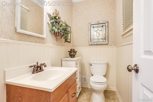 22540 Devonshire St, Woodhaven, MI 48183 - half bath with toilet, wainscoting, vanity, and tile patterned floors