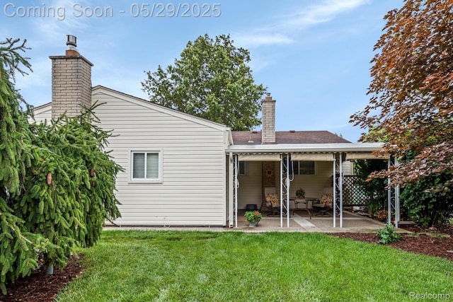 22540 Devonshire St, Woodhaven, MI 48183 - back of property featuring a chimney, a patio area, and a yard