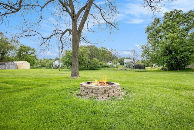 5778 Borland St, Sears, MI 49679 - view of green lawn featuring a fire pit