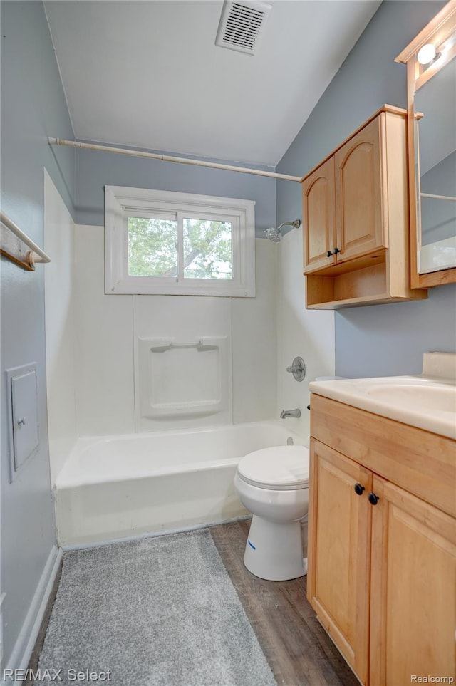 1925 Gilmartin St, Flint, MI 48503 - bathroom with shower / washtub combination, vanity, toilet, lofted ceiling, and wood finished floors