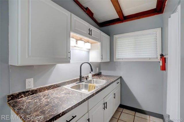 1925 Gilmartin St, Flint, MI 48503 - kitchen featuring a sink, white cabinets, and dark countertops
