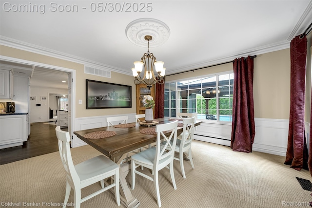 4462 Barchester Dr, Bloomfield Hills, MI 48302 - dining space featuring ornamental molding, a baseboard heating unit, light colored carpet, a wainscoted wall, and a chandelier