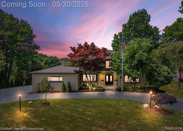 4462 Barchester Dr, Bloomfield Hills, MI 48302 - view of front facade featuring french doors, a front lawn, and brick siding