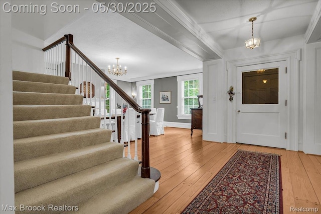 27160 Scenic, Franklin, MI 48025 - entrance foyer with a chandelier, stairway, light wood-style flooring, and baseboards