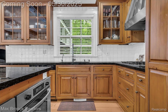 27160 Scenic, Franklin, MI 48025 - kitchen with wall chimney range hood, stainless steel appliances, a sink, dark stone countertops, and backsplash