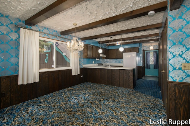 6221 Honeymoon Dr, Lakeview, MI 48850 - kitchen featuring a chandelier, wainscoting, carpet, wallpapered walls, and beam ceiling