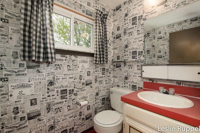 6221 Honeymoon Dr, Lakeview, MI 48850 - bathroom featuring toilet, vanity, backsplash, and tile walls