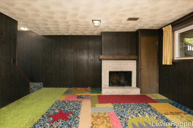 6221 Honeymoon Dr, Lakeview, MI 48850 - living room with wooden walls, a fireplace, and carpet