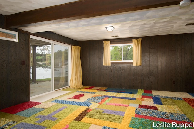 6221 Honeymoon Dr, Lakeview, MI 48850 - unfurnished bedroom featuring access to outside, wood walls, and light carpet
