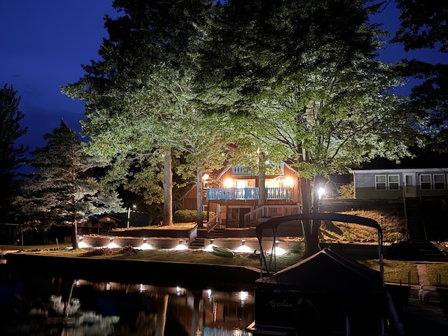 6221 Honeymoon Dr, Lakeview, MI 48850 - back of house at night with a wooden deck and stairway
