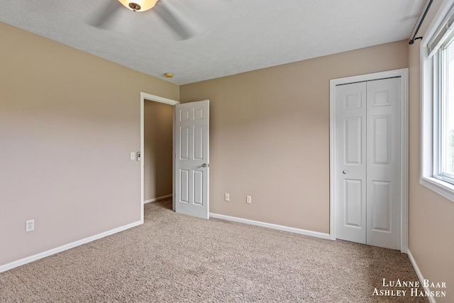 7300 Orchard View Dr NE, Rockford, MI 49341 - unfurnished bedroom featuring carpet floors, multiple windows, baseboards, and a closet