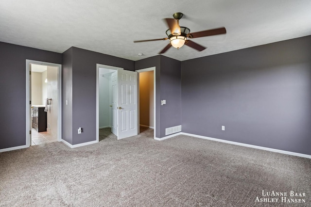 7300 Orchard View Dr NE, Rockford, MI 49341 - unfurnished bedroom with baseboards, carpet flooring, a walk in closet, and ceiling fan