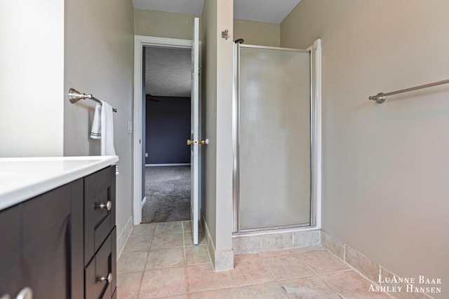 7300 Orchard View Dr NE, Rockford, MI 49341 - bathroom featuring a shower stall, vanity, baseboards, and tile patterned floors