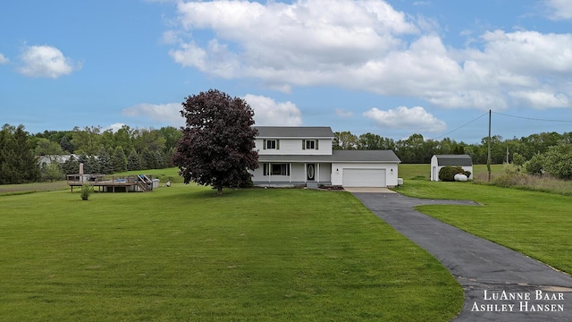7300 Orchard View Dr NE, Rockford, MI 49341 - traditional home with a garage, asphalt driveway, and a front lawn