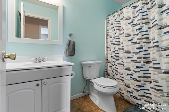 7300 Orchard View Dr NE, Rockford, MI 49341 - bathroom with toilet, vanity, baseboards, and a shower with shower curtain
