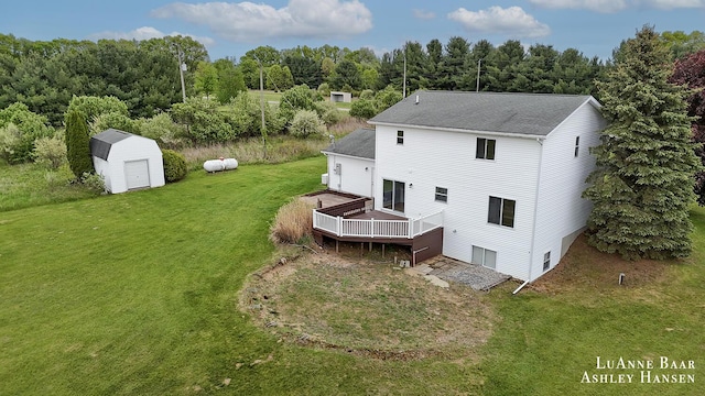 7300 Orchard View Dr NE, Rockford, MI 49341 - back of property with a deck, a lawn, and a shingled roof