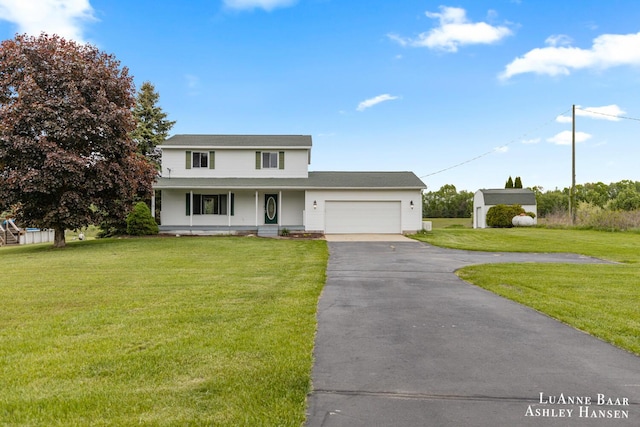 7300 Orchard View Dr NE, Rockford, MI 49341 - traditional-style home featuring asphalt driveway, a porch, a garage, and a front lawn