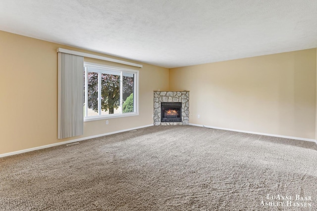 7300 Orchard View Dr NE, Rockford, MI 49341 - unfurnished living room featuring a stone fireplace, carpet, and baseboards