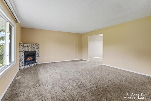 7300 Orchard View Dr NE, Rockford, MI 49341 - unfurnished living room with plenty of natural light, carpet floors, and baseboards