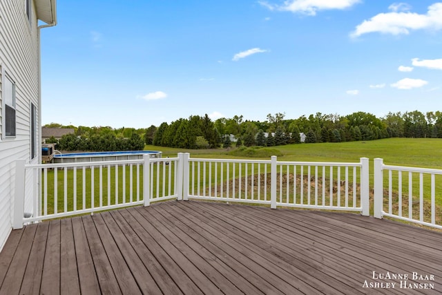 7300 Orchard View Dr NE, Rockford, MI 49341 - deck featuring a swimming pool, a lawn, and view of scattered trees