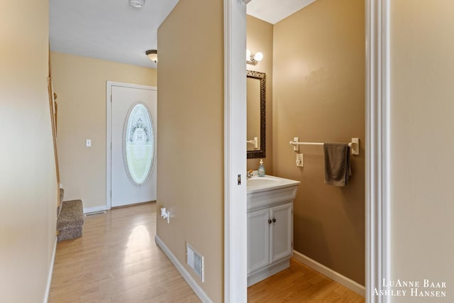 7300 Orchard View Dr NE, Rockford, MI 49341 - bathroom with wood finished floors, vanity, and baseboards
