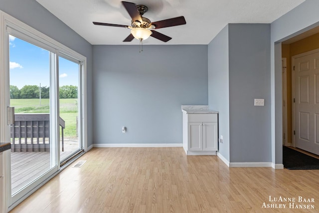 7300 Orchard View Dr NE, Rockford, MI 49341 - unfurnished room with plenty of natural light, ceiling fan, light wood-type flooring, and baseboards