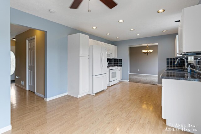 7300 Orchard View Dr NE, Rockford, MI 49341 - kitchen with white appliances, a chandelier, decorative backsplash, white cabinets, and ceiling fan