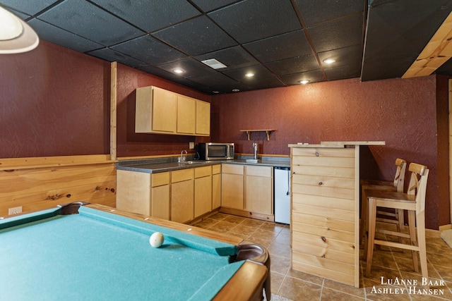 7300 Orchard View Dr NE, Rockford, MI 49341 - kitchen with light brown cabinets, billiards table, a paneled ceiling, stainless steel microwave, and dark countertops