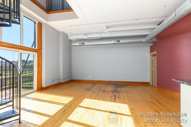 600 Broadway Ave NW Unit 414, Grand Rapids, MI 49504 - empty room featuring hardwood / wood-style floors, baseboards, and a towering ceiling