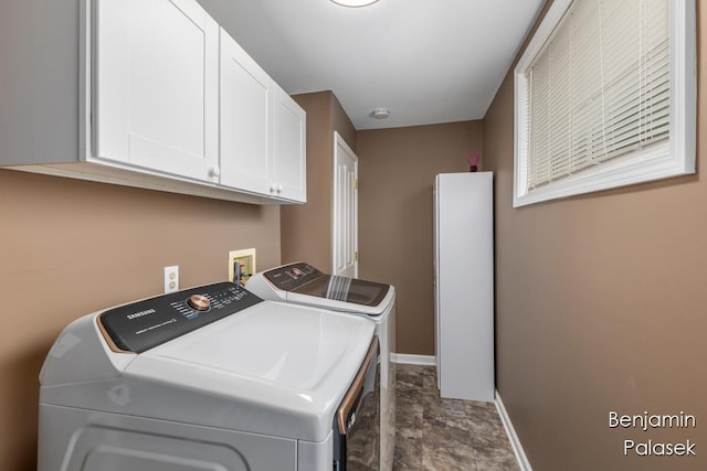 5826 W 124th St, Grant, MI 49327 - laundry area featuring washing machine and dryer, baseboards, cabinet space, and stone finish flooring