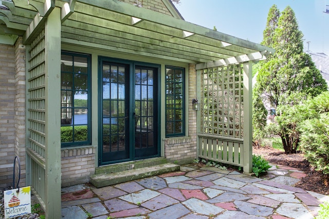18957 N Fruitport Rd, Spring Lake, MI 49456 - view of exterior entry featuring brick siding and a pergola