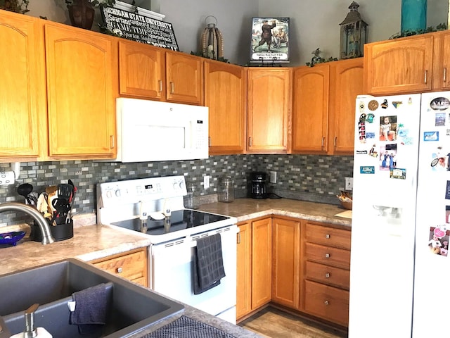 5883 Thistlewood Ave, Scotts, MI 49088 - kitchen featuring white appliances, a sink, light countertops, and decorative backsplash