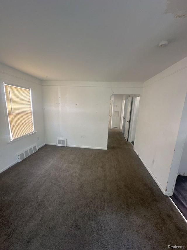 18932 Riverview St, Detroit, MI 48219 - spare room with dark colored carpet, a smoke detector, and baseboards