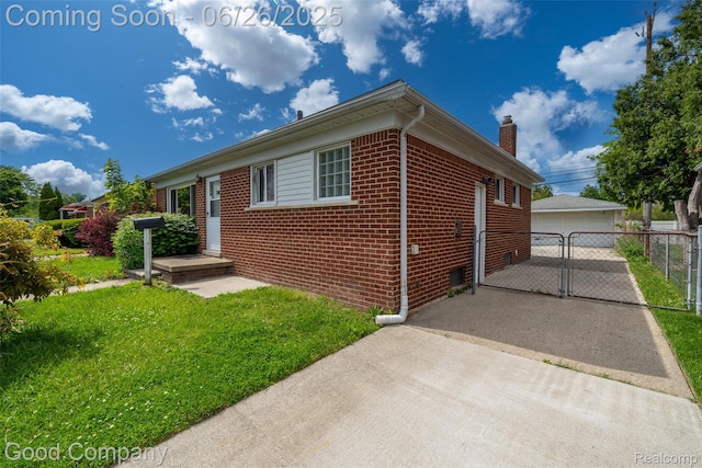 26730 W Davison, Redford, MI 48239 - view of front of property with brick siding, a chimney, a garage, a gate, and an outbuilding