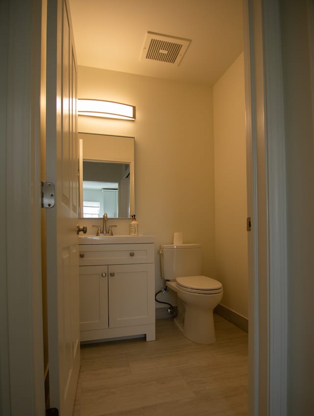 20072 Rodeo, Southfield, MI 48075 - half bath featuring toilet, wood finished floors, vanity, and baseboards