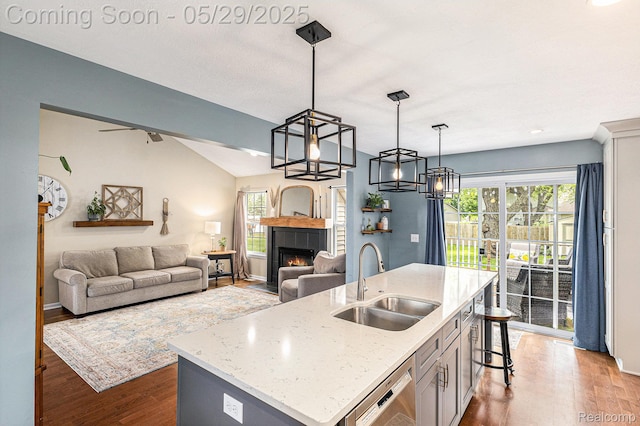 1411 Vollar Dr, Flint, MI 48532 - kitchen featuring a sink, stainless steel dishwasher, wood finished floors, an island with sink, and healthy amount of natural light