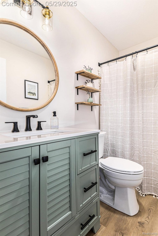 1411 Vollar Dr, Flint, MI 48532 - full bathroom featuring toilet, wood finished floors, and vanity