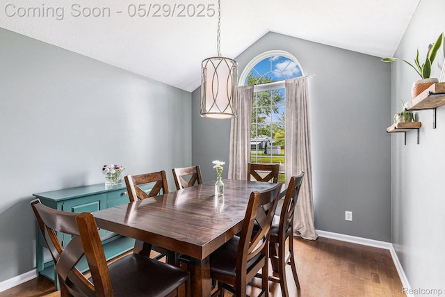 1411 Vollar Dr, Flint, MI 48532 - dining room featuring vaulted ceiling, wood finished floors, and baseboards