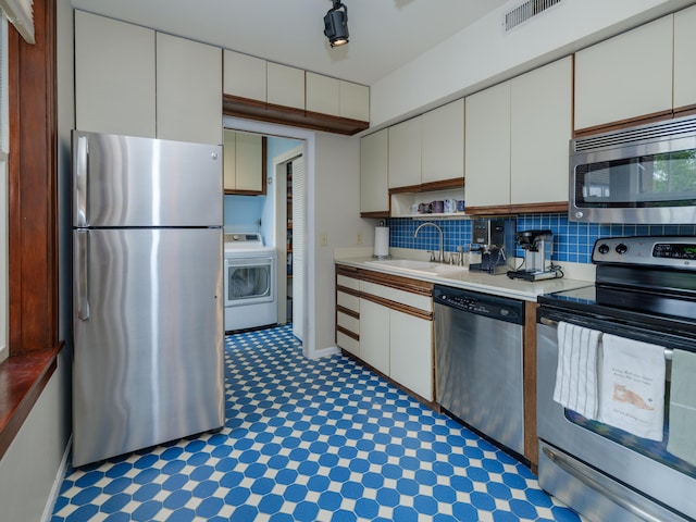 471 W S St Unit 207, Kalamazoo, MI 49007 - kitchen featuring appliances with stainless steel finishes, washer / clothes dryer, a sink, and light countertops