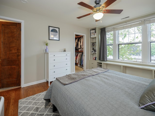 471 W S St Unit 207, Kalamazoo, MI 49007 - bedroom with multiple windows, a spacious closet, wood finished floors, and a closet