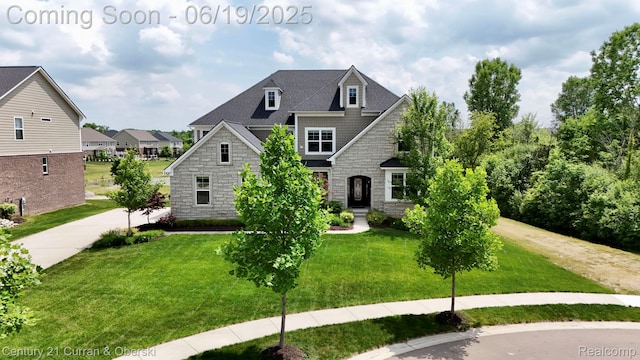 51553 Bloom Ct, South Lyon, MI 48178 - view of front of property featuring stone siding and a front yard