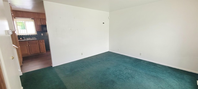 6121 Eldon Rd, Mount Morris, MI 48458 - unfurnished room featuring dark carpet, baseboards, and a sink