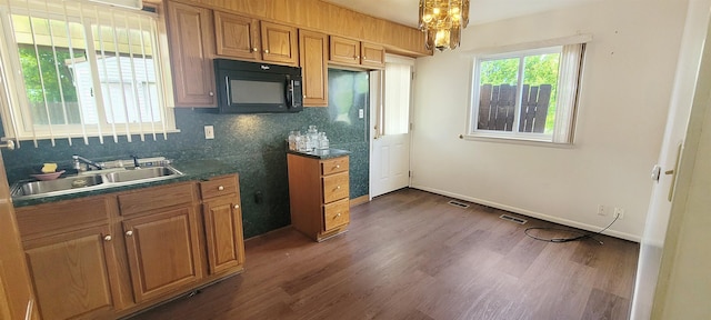 6121 Eldon Rd, Mount Morris, MI 48458 - kitchen featuring black microwave, a sink, decorative backsplash, and dark wood-type flooring