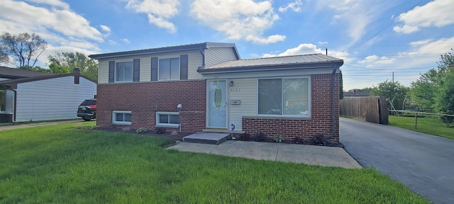 6121 Eldon Rd, Mount Morris, MI 48458 - split level home with brick siding, metal roof, and driveway