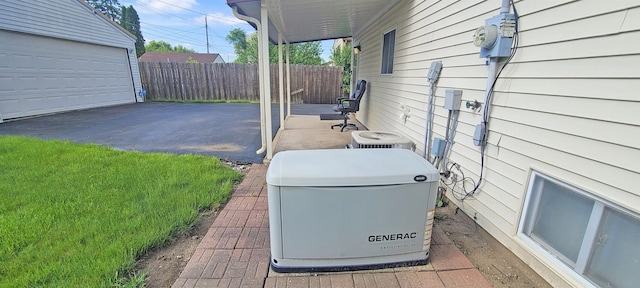 6121 Eldon Rd, Mount Morris, MI 48458 - view of patio featuring central air condition unit and a garage