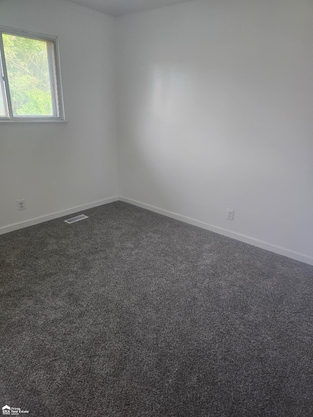 5406 Bermuda Ln, Flint, MI 48505 - spare room featuring baseboards and dark carpet