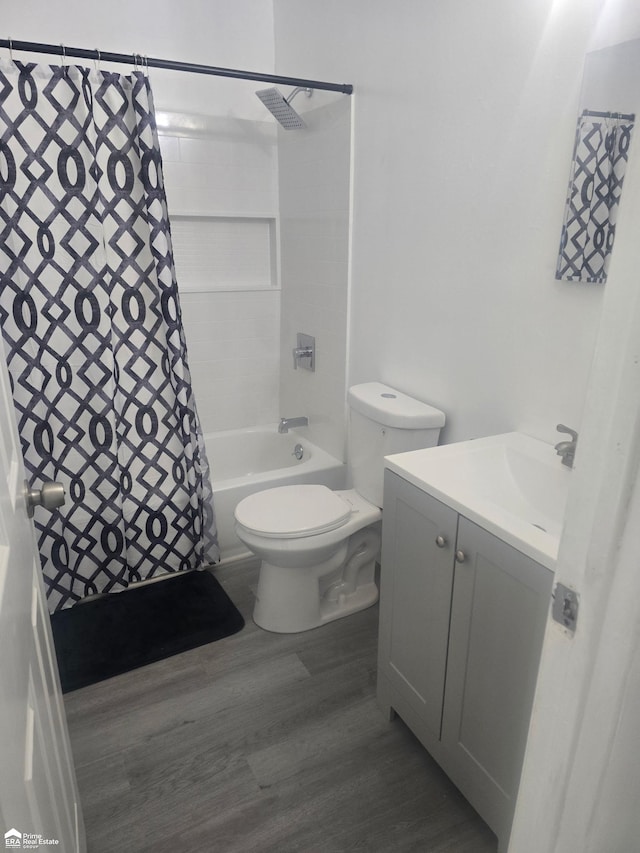 5406 Bermuda Ln, Flint, MI 48505 - bathroom featuring wood finished floors, toilet, vanity, and shower / bathtub combination with curtain